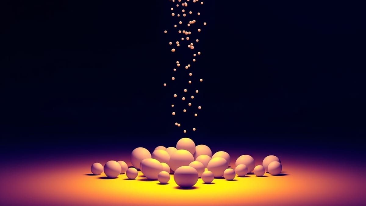 Scattered pebbles pouring into a funnel of light and emerging as a few smooth identical spheres.