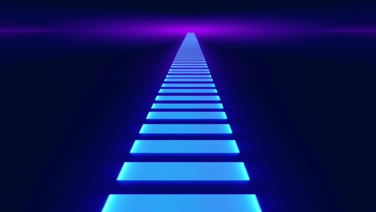 A road fading into fog with a parallel line of glowing stepping stones continuing past it toward clear distance.