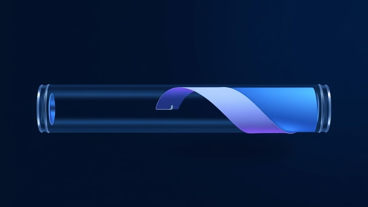 A long glass tube holding a very long paper ribbon, with a small clamp pinching only one short segment while the rest curls a