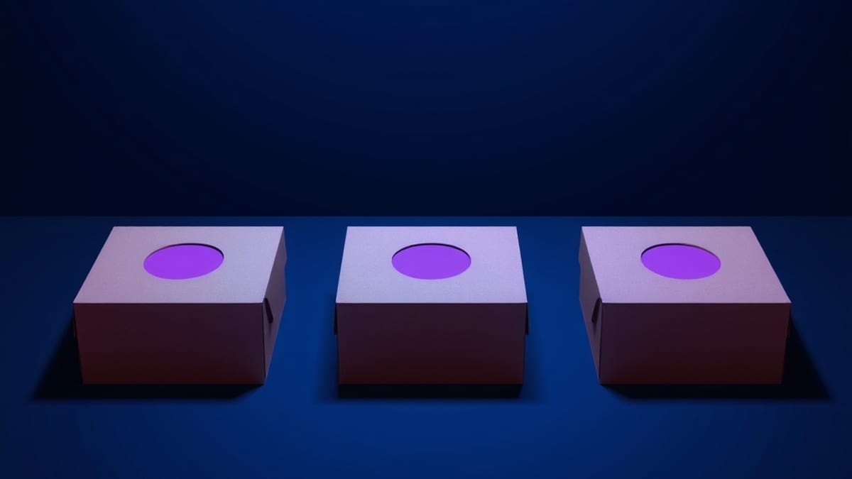Three closed boxes with different geometric cutouts on their lids, each casting a distinct shadow pattern on the floor.