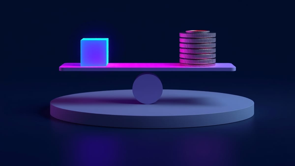 A balance scale weighing one glowing pixel cube against a stack of coins, with one coin lifted out and set aside.
