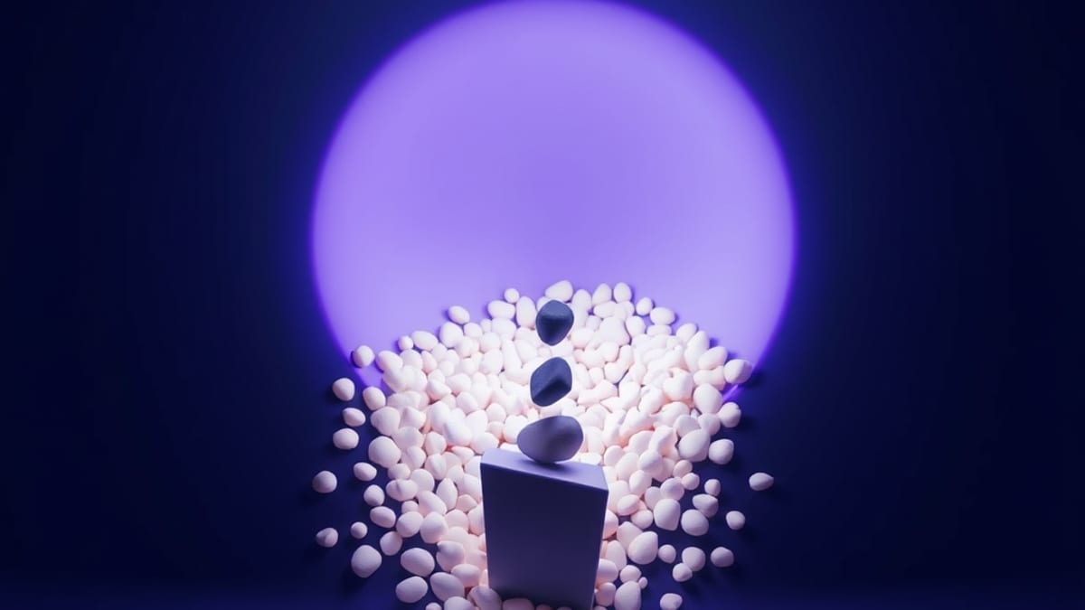 Pale pebbles spread wide across a funnel, narrowing to a bright channel where a few dark stones land as one solid block.